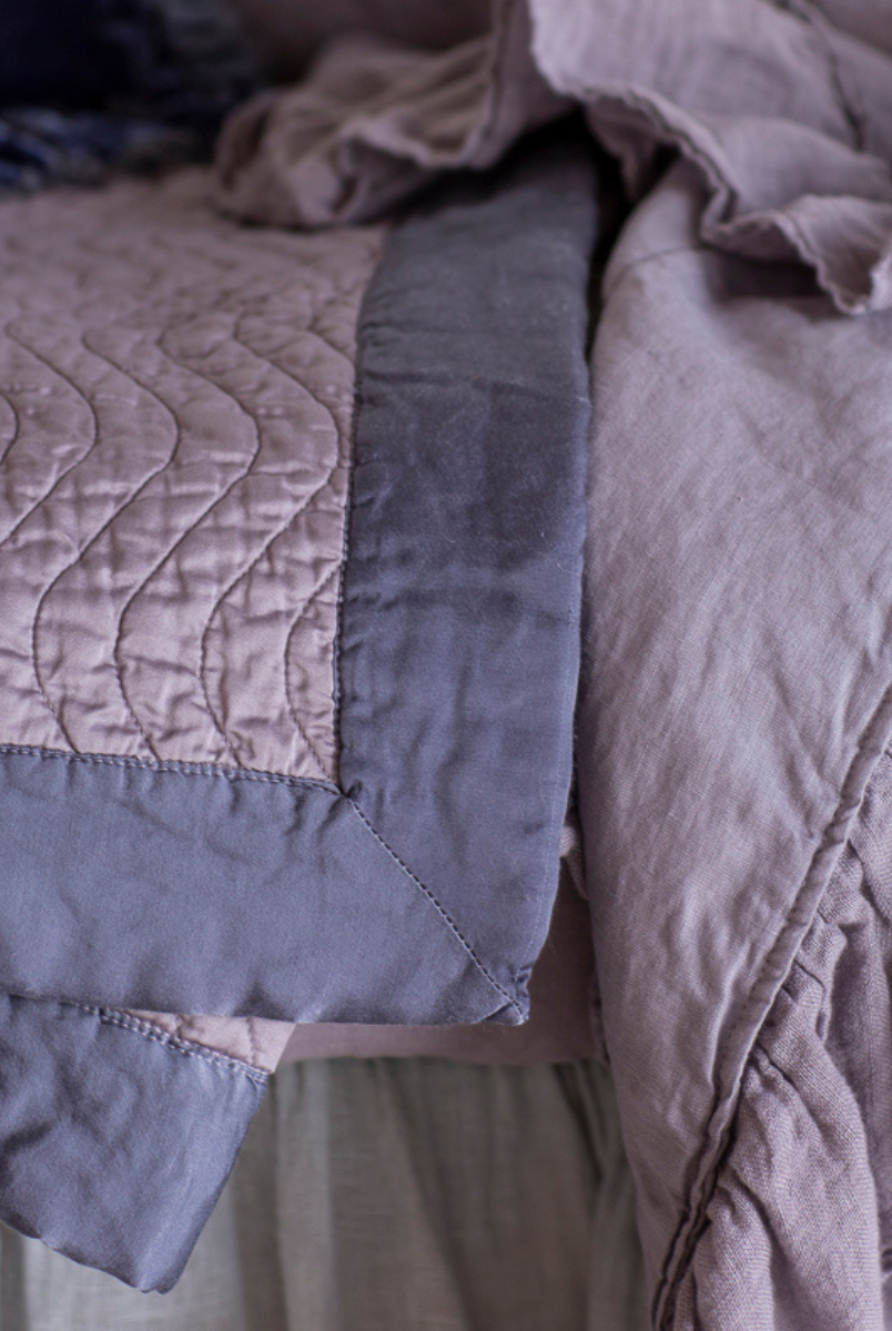 [allvariants]: a close up of quilted cotton sateen baby blanket and linen whisper baby blanket both in French Lavender.