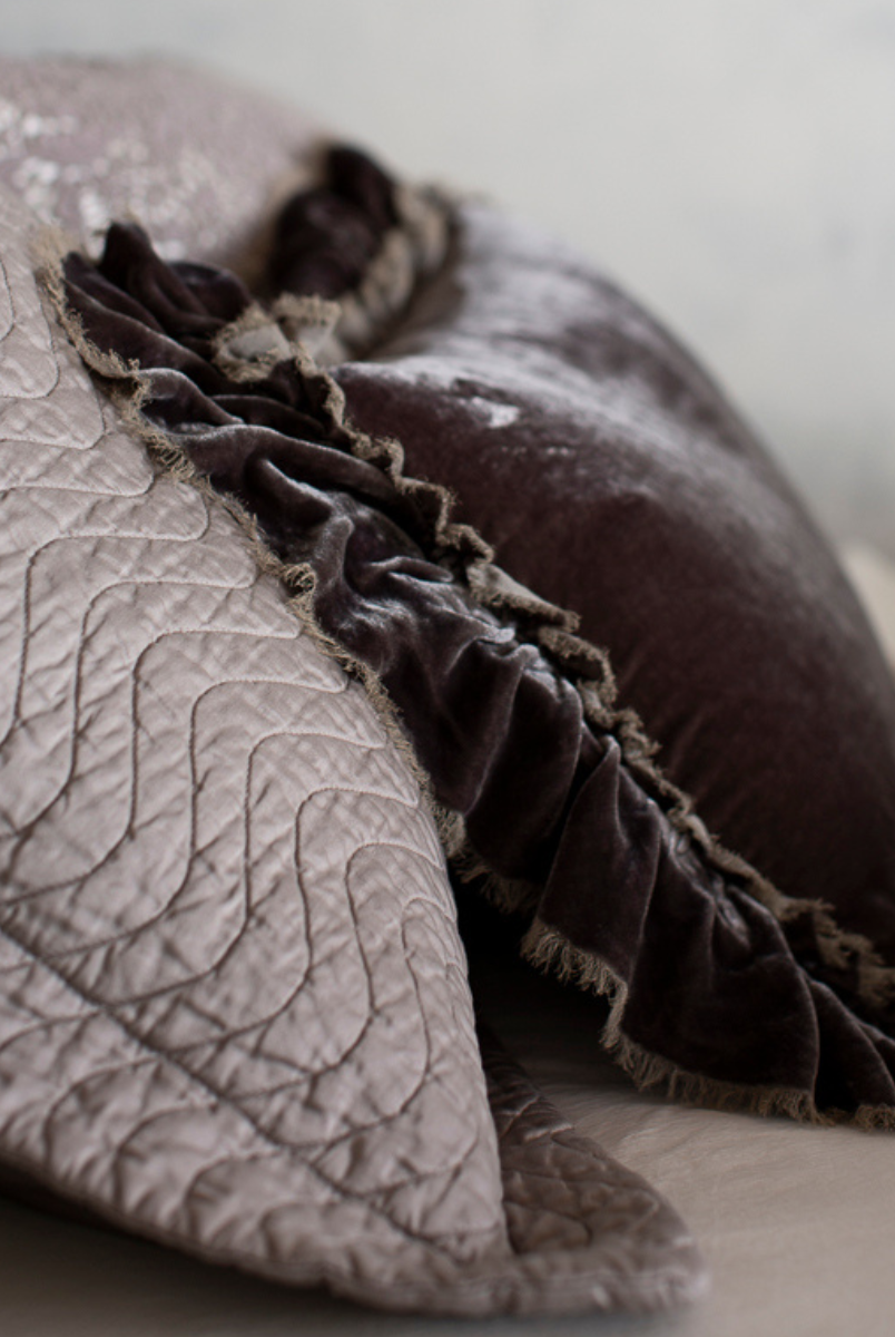 [allvariants]: close up of the side view of a quilted cotton sateen sham with silk velvet throw pillow with raw edges propped up against the pillow sham - both in grey tones. 