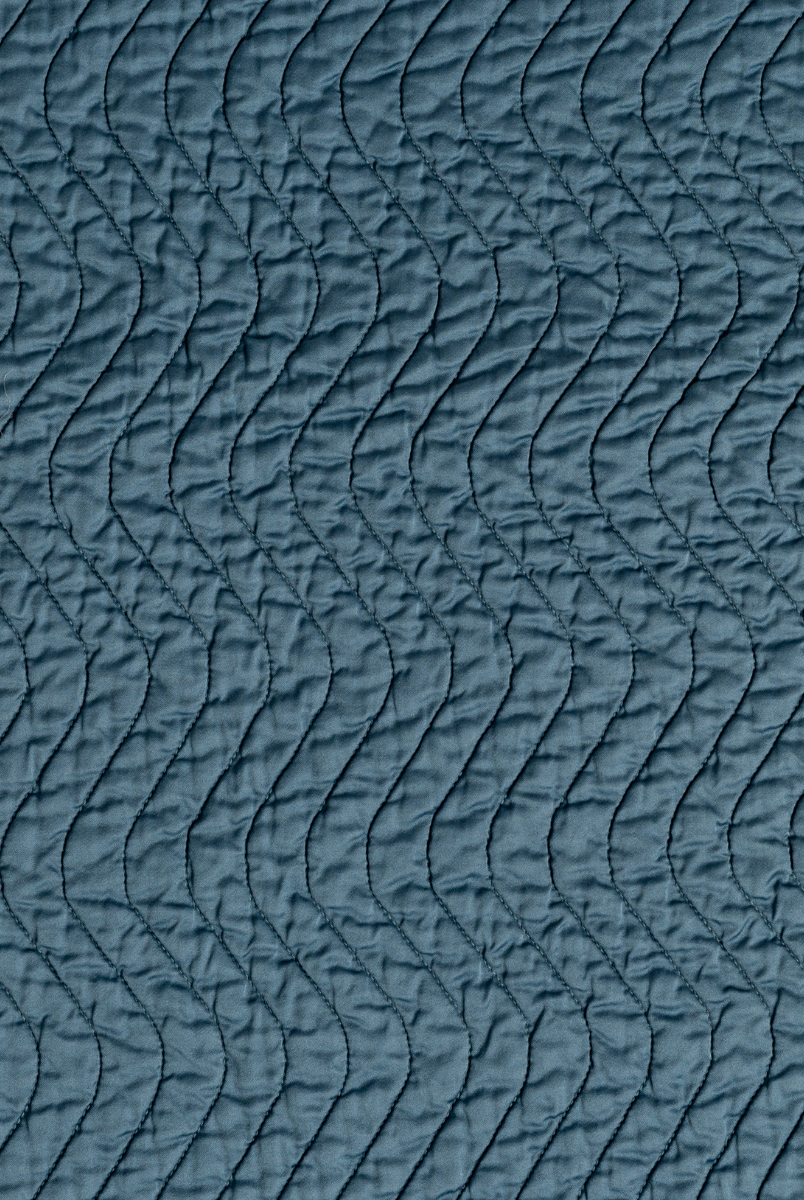Cenote: A close up of quilted cotton sateen fabric in cenote, a vibrant, ocean-inspired blue-green.