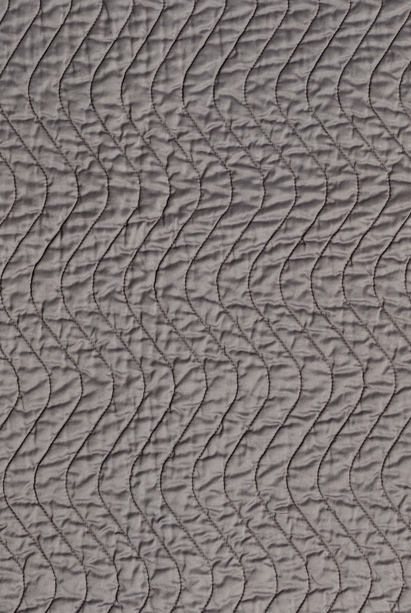 Fig: A close up of quilted cotton sateen fabric in fig, a richly saturated purple-garnet.
