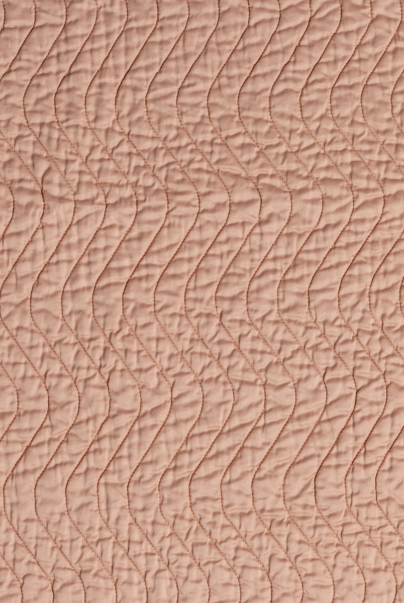 Rouge: A close up of quilted cotton sateen fabric in rouge, a mid-tone blush pink.