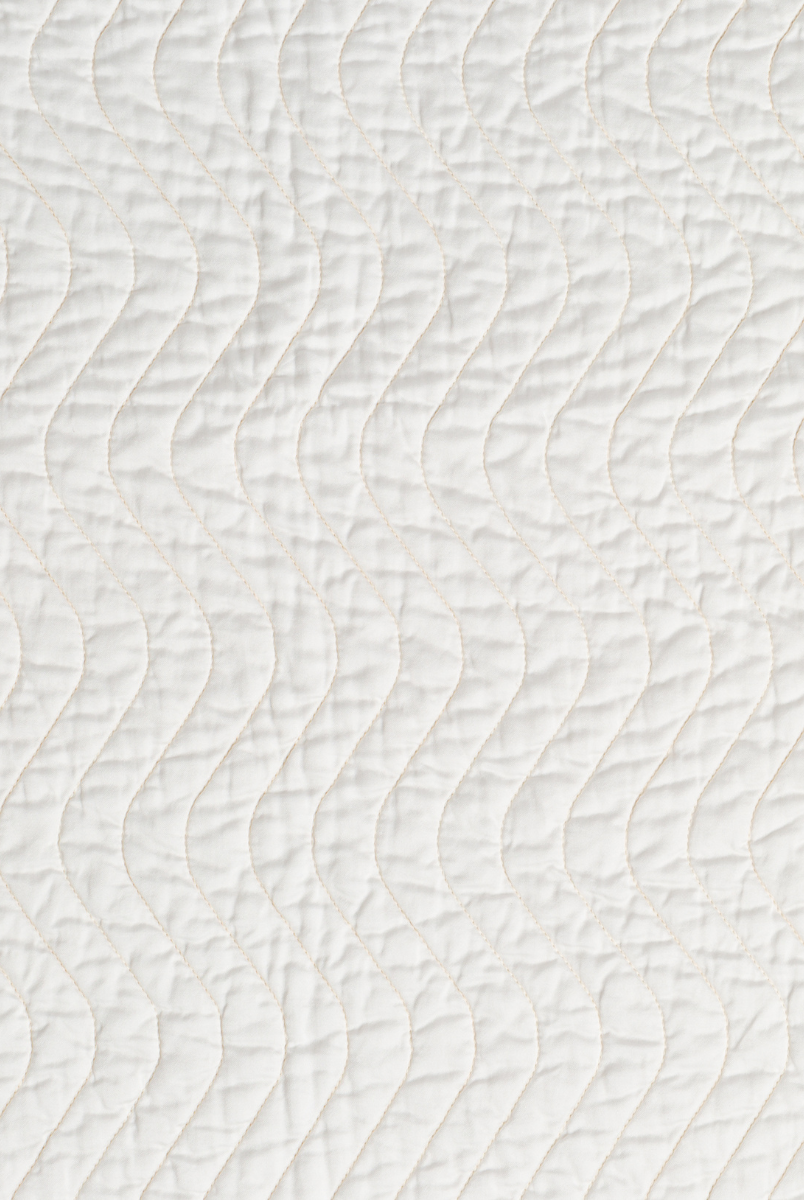 Winter White: A close up of quilted cotton sateen fabric in winter white, softer and warmer in tone than classic white.