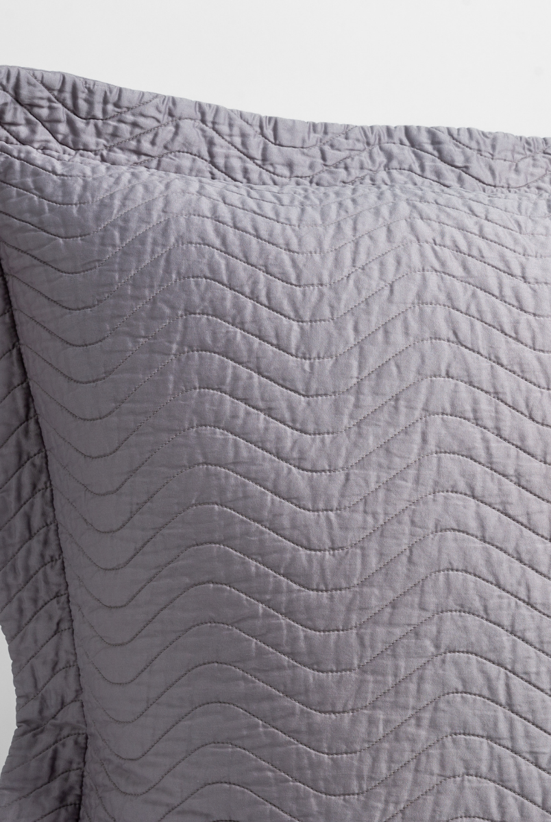 French Lavender: a close up of a pillow corner showing the flange framing quilted cotton sateen shot against a white background. 